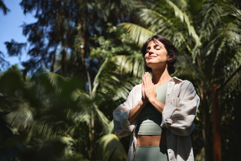 Happy,Calm,Young,Hispanic,Woman,Holding,Hands,In,Namaste,Meditating