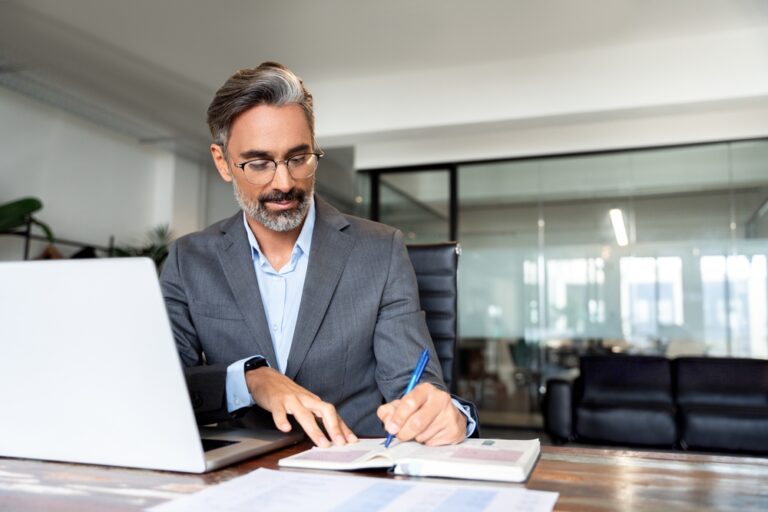 Middle-age,Hispanic,Man,Using,Laptop,Computer,For,Business,Studying,,Watch