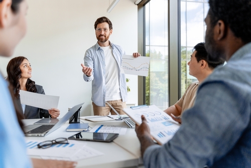 Marketing,Manager,Showing,Growth,Chart,To,His,Colleagues,During,A