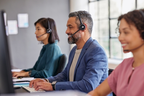 Mixed,Race,Call,Center,Agent,Smiling,While,Assisting,A,Customer