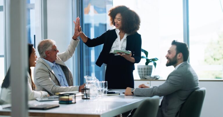 High,Five,,Meeting,And,Tablet,With,Business,People,In,Boardroom