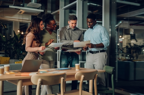 Multiracial,Colleagues,Analyzing,Documents,,Discussing,Ideas,,And,Working,Together,On