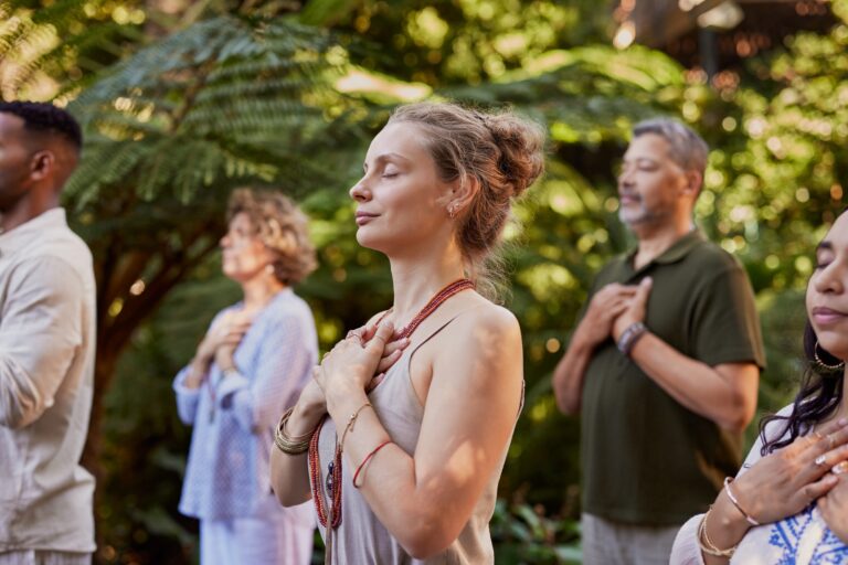 Group,Of,People,Standing,Outdoors,With,Hands,On,Their,Hearts,