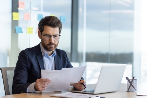 Serious,Thinking,Businessman,Behind,Paper,Work,,Mature,Experienced,Boss,Working
