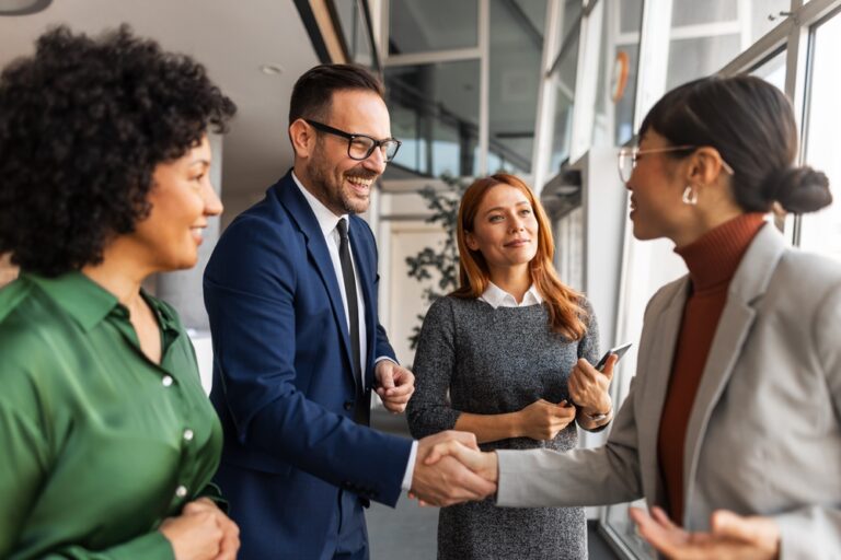 A,Group,Of,Business,Professionals,In,Formal,Attire,Greet,Each