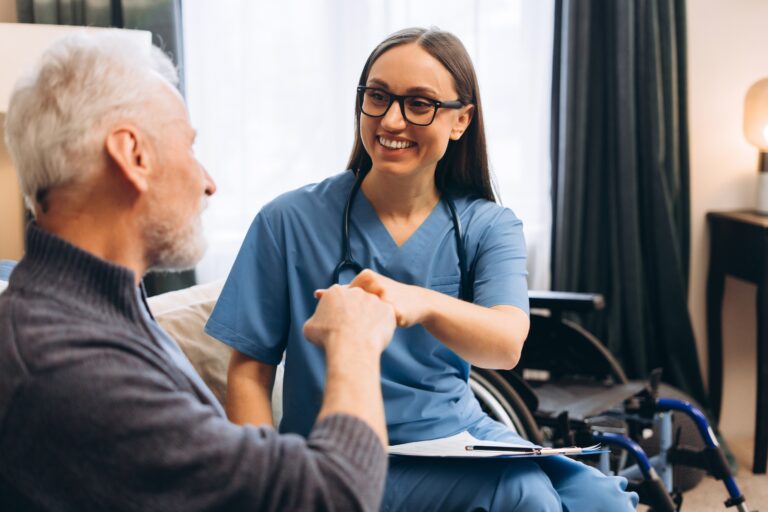 Smiling,Woman,Nurse,And,Elderly,Patient,Fist,Bumping,For,Support