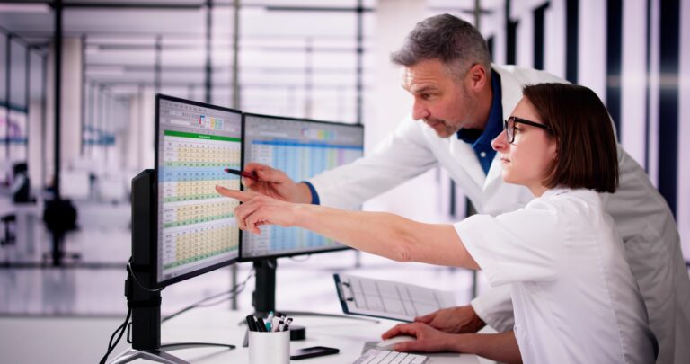 Hospital,Doctor,Using,Spreadsheet,For,Billing,Codes,On,Desktop